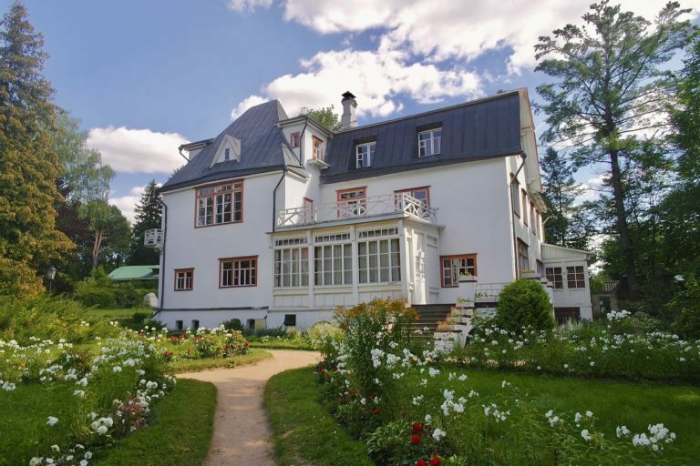a large white house with a garden