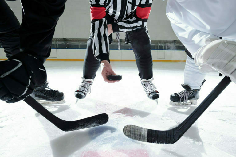 a group of people playing hockey